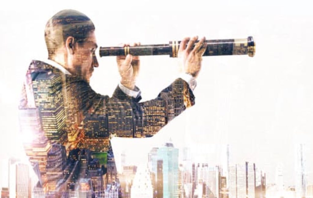 На рисунке изображен бизнесмен, смотрящий в будущее